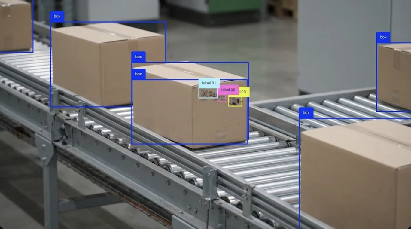 Bounding boxes drawn by a trained vision model around packages on a conveyor.